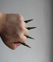 Upper Side Of Human Fist With Bullets Clenched Between Fingers photo