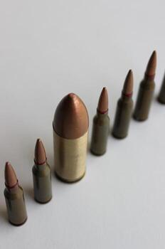 Conceptual photo on the theme of diversity with a large cartridge in a line of same cartridges another size