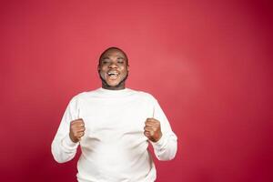 Handsome hispanic man wearing casual clothes celebrating surprised and amazed for success with arms raised photo