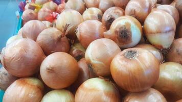 Big pile of onions in the market photo