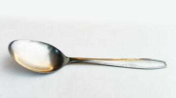 Clean shiny spoon isolated on white photo