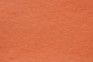 Synthetic orange leather for background. Closeup detail view of texture decoration material, pattern photo