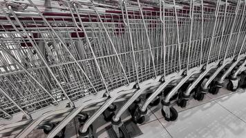 Row of empty shopping carts lined up at a supermarket, concept of retail industry and consumerism, suitable for sales promotions or Black Friday shopping themes video