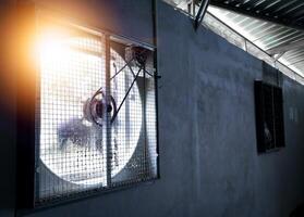 Big industrial Exhaust fan in a factory. Ventilation of plant building. With Shiny light. photo