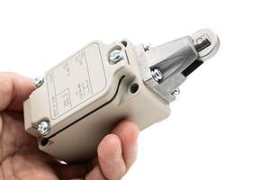 Limit switch sensor of the machine. limit switch for mechanical movement and actuators limits. isolated on white background of limit switch, control device, electrical equipment in control system. photo
