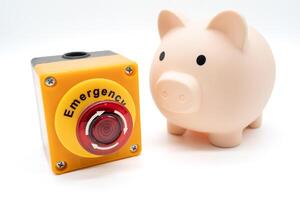 Concept of emergency savings fund. A piggy bank and stop button. money saving for emergency money. photo