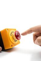 Stop Button and the Hand of Worker About to Press it. emergency stop button. Big Red emergency button or stop button for manual pressing. isolated on white background. photo