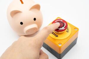 Concept of emergency savings fund. A piggy bank and stop button. money saving for emergency money. photo