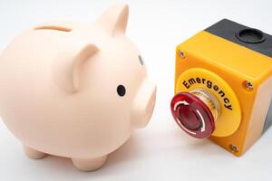 Concept of emergency savings fund. A piggy bank and stop button. money saving for emergency money. photo