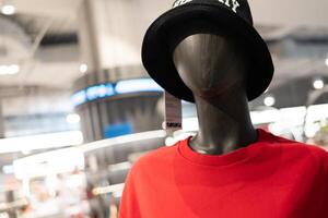 Mannequin wearing the red t shirt in the clothing store. Portrait mannequin. photo