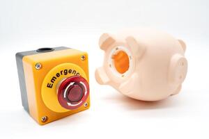 Concept of emergency savings fund. A piggy bank and stop button. money saving for emergency money. photo