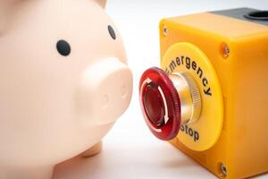 Concept of emergency savings fund. A piggy bank and stop button. money saving for emergency money. photo