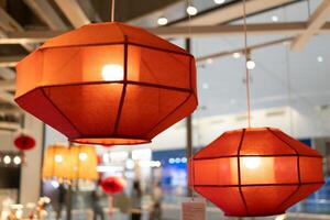 Red lamp shade. Hanging Lamp with Red Shade, Modern Chandelier with Light Bulb. photo