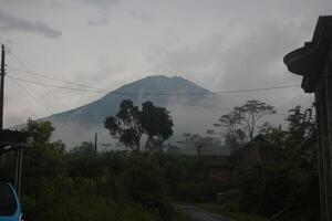 Mount Sumbing is located in Central Java during the rainy season photo