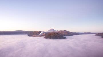 Spectacular view of Mount Bromo with the sea of fog in the morning. This is an active volcano part of the Tengger massif, in East Java, Indonesia. photo