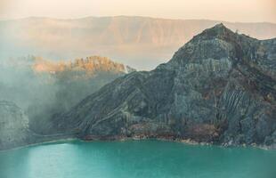 Acid lake view from crater of Kawah Ijen volcano in Java island, Indonesia at dawn. photo