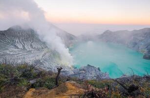 Beautiful scenery view of Kawah Ijen volcano in Java island of Indonesia at dawn. Ijen volcano complex has some of the highest levels of sulfur one of the more dangerous places on Earth. photo