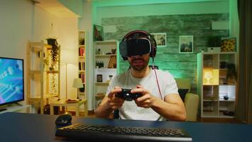 Pov of angry young man wearing virtual reality headset after losing at online games. Wireless controller. video