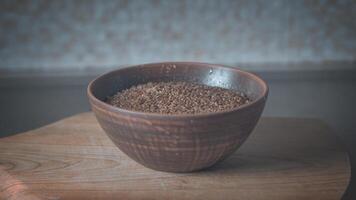 Brown clay plate with buckwheat and brown linen. CINEMA photo