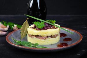 Mashed potato with beef, caramelized onion and cherry sauce photo