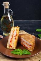 Sandwiches fried in breadcrumbs with ham, cheese and tomatoes photo