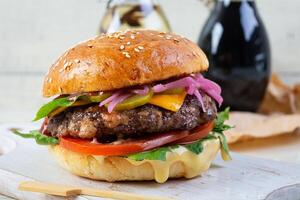 Delicious burger with beef meat, homemade bun and mayo photo