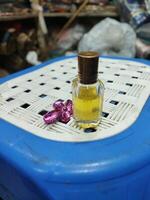 a small bottle of perfume sitting on a red cloth photo