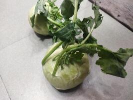 two white vegetables sitting on a tiled floor photo