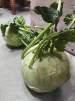 two white vegetables sitting on a tiled floor photo