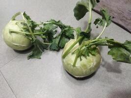 two white vegetables sitting on a tiled floor photo