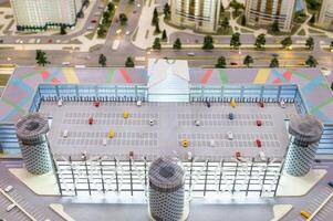 A miniature city on the table. Layout of a parking lot with cars. photo