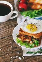 Sandwich with eggs, chicken, cucumber and lettuce on a wooden background. Selective focus. copy space photo