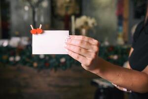 Woman hand holds paper card with two heart pins. Valentines day concept. Copyspace for text. photo