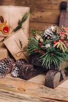 Christmas Gifts with Boxes on Wooden Background. Vintage Style. Closeup, selective focus. Toy, bear, sled. Christmas concept. photo