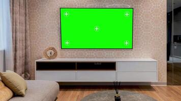 LED smart TV screen with a blank green background in the living room. Chroma key screen for advertising. Mock Up Green Screen Chromakey Display with Isolated Placeholder. video