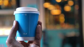 pov of holding blue color takeaway coffee cup video