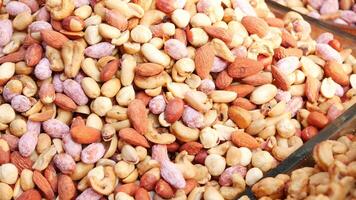 close up of many mixed nuts selling at market video