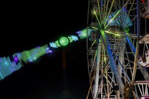 Mexican fair with rides and lights at night, with space for text photo