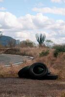 Tires lying on the side of the road, with space for text photo