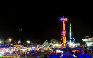 Mexican fair with rides and lights at night, with space for text photo