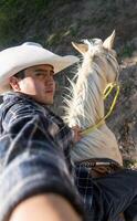 hombre tomando un caminar con amigos en lado de caballo en sombrero mediante semidesierto campo, con espacio para texto foto