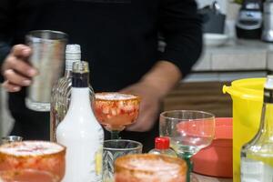 Making strawberry margaritas with ice, chili and lemon photo