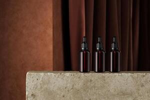 Mockup dropper cosmetic bottle on a stone slab in a backdrop of brown cement and dark curtains. Backdrop for product presentation photo