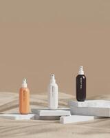 Spray bottles of 3 colors, placed on a beige stone slab in the sand, Soft skin care concept. vertical image. 3D rendering photo