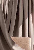 Instead of Terrazzo stone in the backdrop of flowing beige curtains. Choose a focus point. Background for product presentations. 3D illustration photo