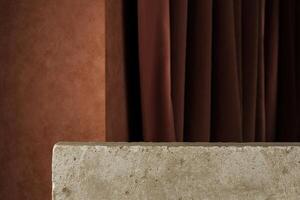 Stone slabs in brown stucco background and dark curtains. Backdrop for product presentation photo
