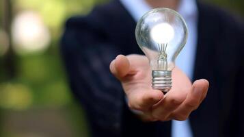 AI generated Close-up, Hand of businessman holding illuminated light bulb, idea, innovation and inspiration concept, Generative AI photo