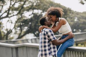 Date couple man and women valentine day. African black lover at park outdoors summer season vintage color tone photo