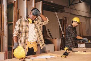 tired fatigue hard work worker in wood workshop factory sweating hot weather photo