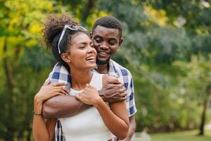 Date couple man and women valentine day. African black lover at park outdoors summer season vintage color tone photo